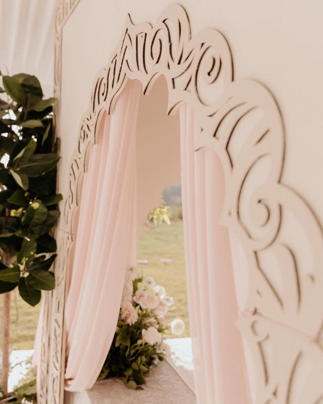Ceiling and wall fabric draping with floral décor installed by InStyle Events