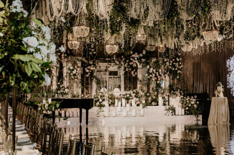 Grand wedding reception hall with chandeliers by InStyle Events